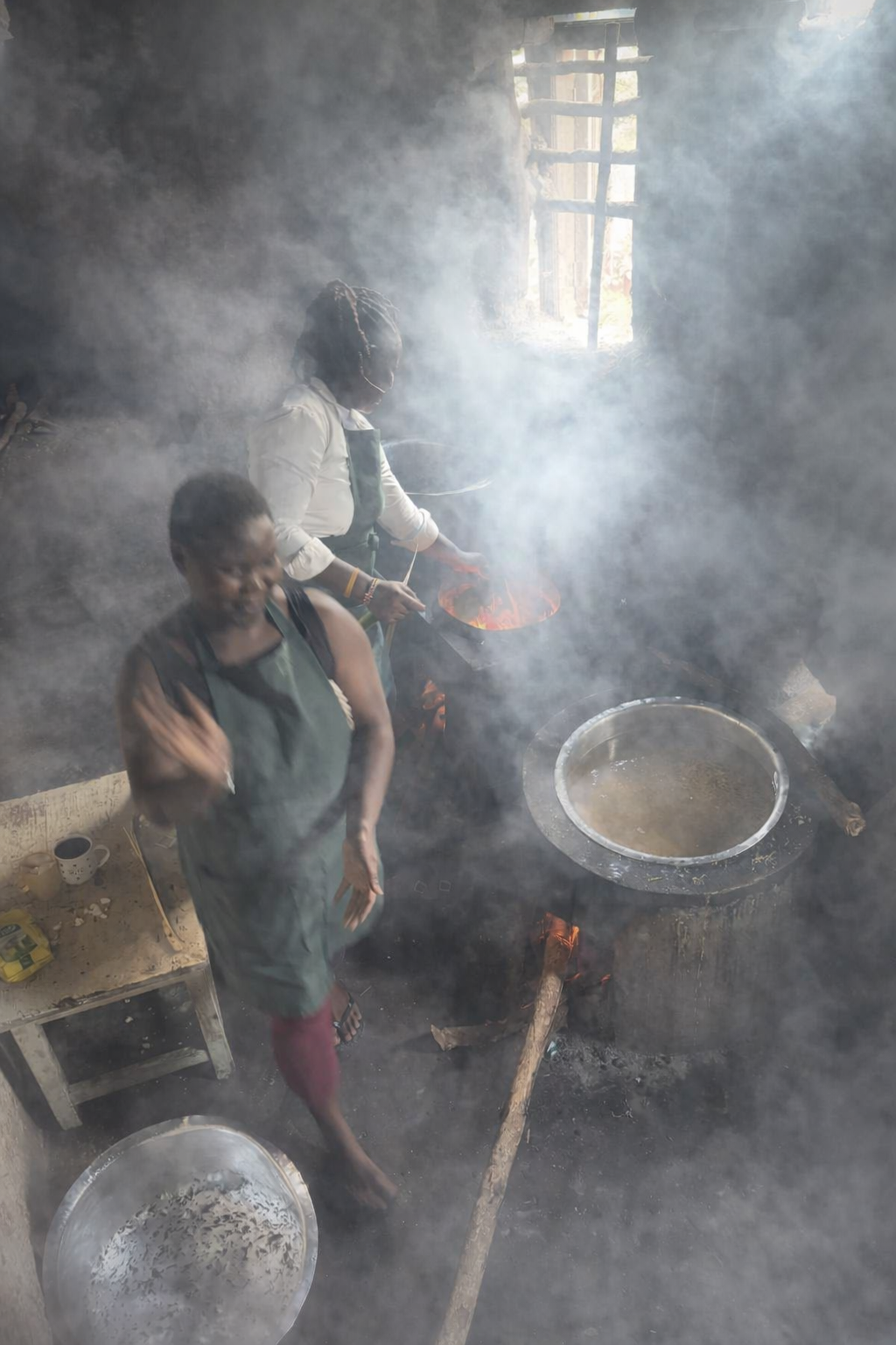 A smoky kitchen with two staff almost obliterated by thick smoke
